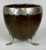 COCONUT CUP, 19th century, with white metal rim and scrolled supports with pad feet, 10.5cms (h)