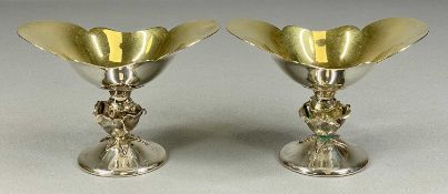 FINE QUALITY PAIR OF SILVER PEDESTAL DISHES with gilded shaped oval silver bowls, bud stems and on