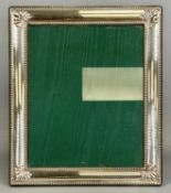 LARGE MODERN RECTANGULAR SILVER FACED PHOTOGRAPH FRAME, embossed with bead rim and shell corners,