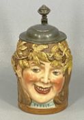 GERMAN STONEWARE STEIN, late 19th century, modelled as a head with garland of hops and leaves, '