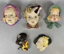 COLLECTION OF ART DECO STYLE WALL MASKS including a Goldscheider example of a child wearing hat,