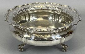 CIRCULAR SILVER FRUIT BOWL with flared, pierced and shaped upper rim, squat form body on three