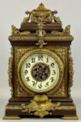A FRENCH OAK & GILDED ORMOLU MANTEL CLOCK, late 19th century, cream ceramic dial with black Arabic