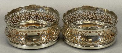 GOOD PAIR OF SILVER PLATED WINE BOTTLE COASTERS, late 19th century with shaped and detailed upper