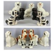 COLLECTION OF 19TH CENTURY STAFFORDSHIRE SEATED SPANIELS, various colours and sizes, singles and