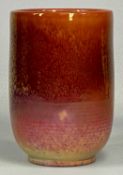 ROYAL LANCASTRIAN VASE of cylindrical form, red mottled lustre glaze, impressed marks, 15.5cms (h)
