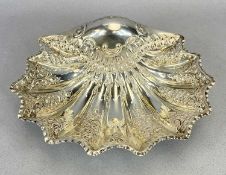 SCALLOP FORM SILVER BOWL with each rib having scroll and floral embossed detail, grip handle end,
