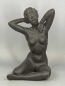 GILBERT CARRADINE (20TH CENTURY) black bisque nude of seated female yawning, signed on base, 25.5cms