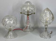 THREE CLEAR CUT GLASS TABLE LAMPS, early 20th century with circular spread feet, baluster columns