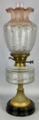 VICTORIAN OIL LAMP with black ceramic base, embossed brass column, faceted clear glass reservoir,
