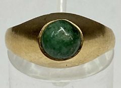 CONTEMPORARY YELLOW GOLD RING set with green cabochon stone, size P, 4gms Provenance: private