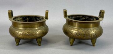 PAIR OF CHINESE BRONZE CENSERS, 19th century with side handles, engraved bodies, standing on three