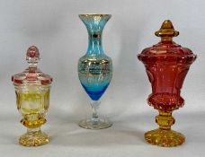 TWO BOHEMIAN COLOURED GLASS POKALS with covers, one etched with hunting scenes, 26cms (h), the other