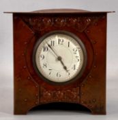 ARTS & CRAFTS MANTEL CLOCK in embossed copper case, circular white dial with Arabic numerals, 8-