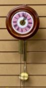CIRCULAR BEECH CASED POSTMAN'S CLOCK, pink and white enamel dial with black Roman numerals, alarm