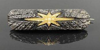 VICTORIAN JET BROOCH inset with gold star, having split seed pearl mounts Provenance: private