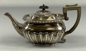 VICTORIAN SILVER TEAPOT of bellied form having gadrooned border, ebonised handle and finial,