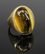 TIGER'S EYE RING in yellow metal mount marked '10k', size T, 20gms Provenance: private collection