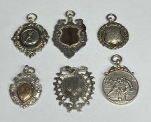 SIX ASSORTED SILVER WATCH FOBS two with gold inserts including cricket, football, TT and military