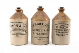 THREE EARLY 20TH CENTURY STONEWARE FLAGONS, all printed with manufacturer's details E. Saxon Merthyr