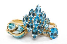 THREE BLUE TOPAZ RINGS, comprising 18ct facet cut ring, 9ct single stone ring with shoulder accents,