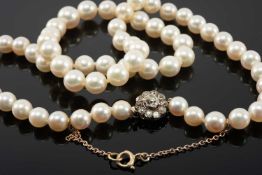 GRADUATED PEAL NECKLACE, 9ct gold safety chain, diamond cluster clasp, the central old cut stone (