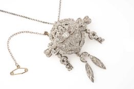 18CT WHITE GOLD DIAMOND ENCRUSTED BROOCH, of pierced floral and scroll design, with drop pendant and