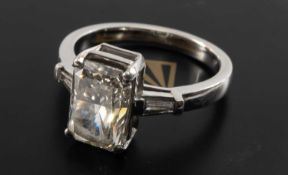 3CT SOLITAIRE DIAMOND RING, the rectangular cut stone set above baguette cut shoulders, on an