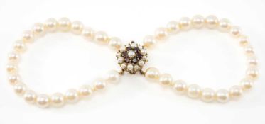DOUBLE ROW PEARL BRACELET, 9ct gold clasp set with garnets and pearls Provenance: private collection
