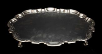 ELIZABETH II SILVER TRAY, oval with scroll shaped edge, raised on four scroll feet, engraved 'With