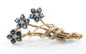 9CT GOLD SAPPHIRE & DIAMOND FLOWER SPRAY BROOCH, composed of three flowers stems with ribbon tie,
