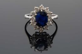 18CT WHITE GOLD & PLATINUM SAPPHIRE & DIAMOND CLUSTER RING, the central oval sapphire (9 x 7mms