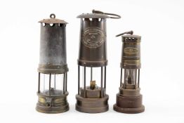 THREE THOMAS R. WILLIAMS MINER'S LAMPS comprising small Investiture commemorative lamp, 16cms (h) (