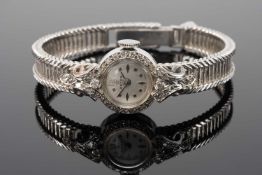 18CT WHITE GOLD ASTER LADIES COCKTAIL WRISTWATCH, with diamond encrusted bezel and scroll mounts,