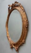 VICTORIAN STYLE GILT OVAL MIRROR with floral moulded borders, fitted with bevelled plate, 72 x 51cms