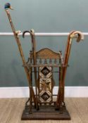 EDWARDIAN CAST IRON STICK STAND with tiled back and assortment of walking canes Provenance:
