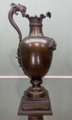 PATINATED BRONZE EWER, after the antique, with dolphin handle, Greenman mask below the clam edge rim