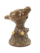 SLIPWARE POTTERY BIRD WHISTLE, modelled as a bird perched upon a conical bark textured stump,