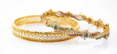 TWO YELLOW METAL BANGLES, comprising a closed bangle set with a band of white stones, together