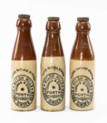 THREE STONEWARE THOMAS & EVANS, PORTH GINGER BEER BOTTLES, 24cms (h) (3) Provenance: private