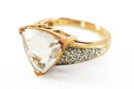 9CT QUARTZ RING, the trilliant cut stone 12mm (diam.), with multiple, presumed, white sapphire