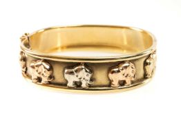 9CT GOLD TRI-COLOUR ELEPHANT BANGLE, hinged with integrated box link clasp, stamped '375', 26.5gms