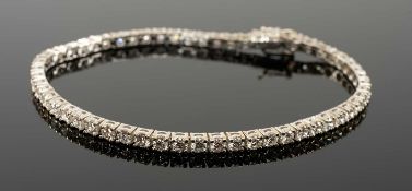 18CT WHITE GOLD DIAMOND LINE / TENNIS BRACELET, set with 56 round cut diamonds, 3.0-3.5cts overall