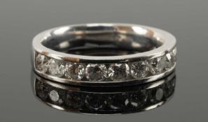 18CT WHITE GOLD DIAMOND HALF ETERNITY RING, channel set with 10 round brilliant cut diamonds, tot