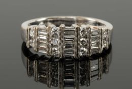 18CT WHITE GOLD DIAMOND RING, the baguette and brilliant cut stones in mille grain alternate