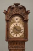 20TH CENTURY WALNUT LONGCASE CLOCK with carving and relief, brass face, Westminster chime and