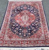 GOOD PERSIAN RUG with large centred medallion in reds and blues with floral patterns, 272 x 395cms