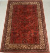 MODERN PERSIAN STYLE WOOLEN RUG, red ground and multi patterned, 242 x 170cms Provenance: private