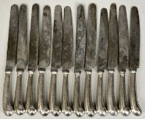TWELVE ANTIQUE TABLE KNIVES, crested silver pistol grips, steel blades, eleven stamped 'Garrard',