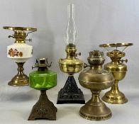 OIL LAMPS including cast iron based examples, one with green glass reservoir, copper example etc.